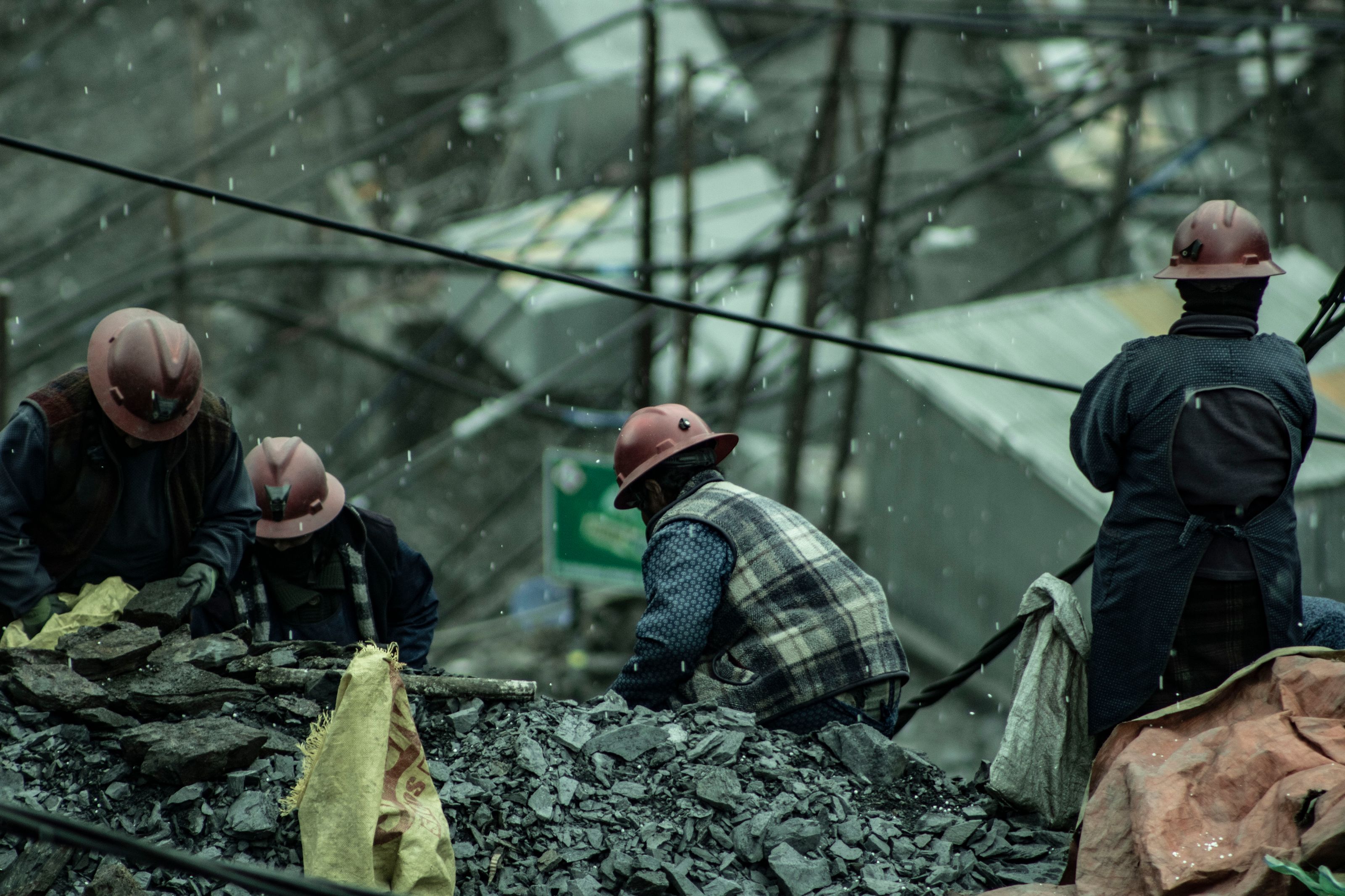 Miners working in wet, rugged conditions