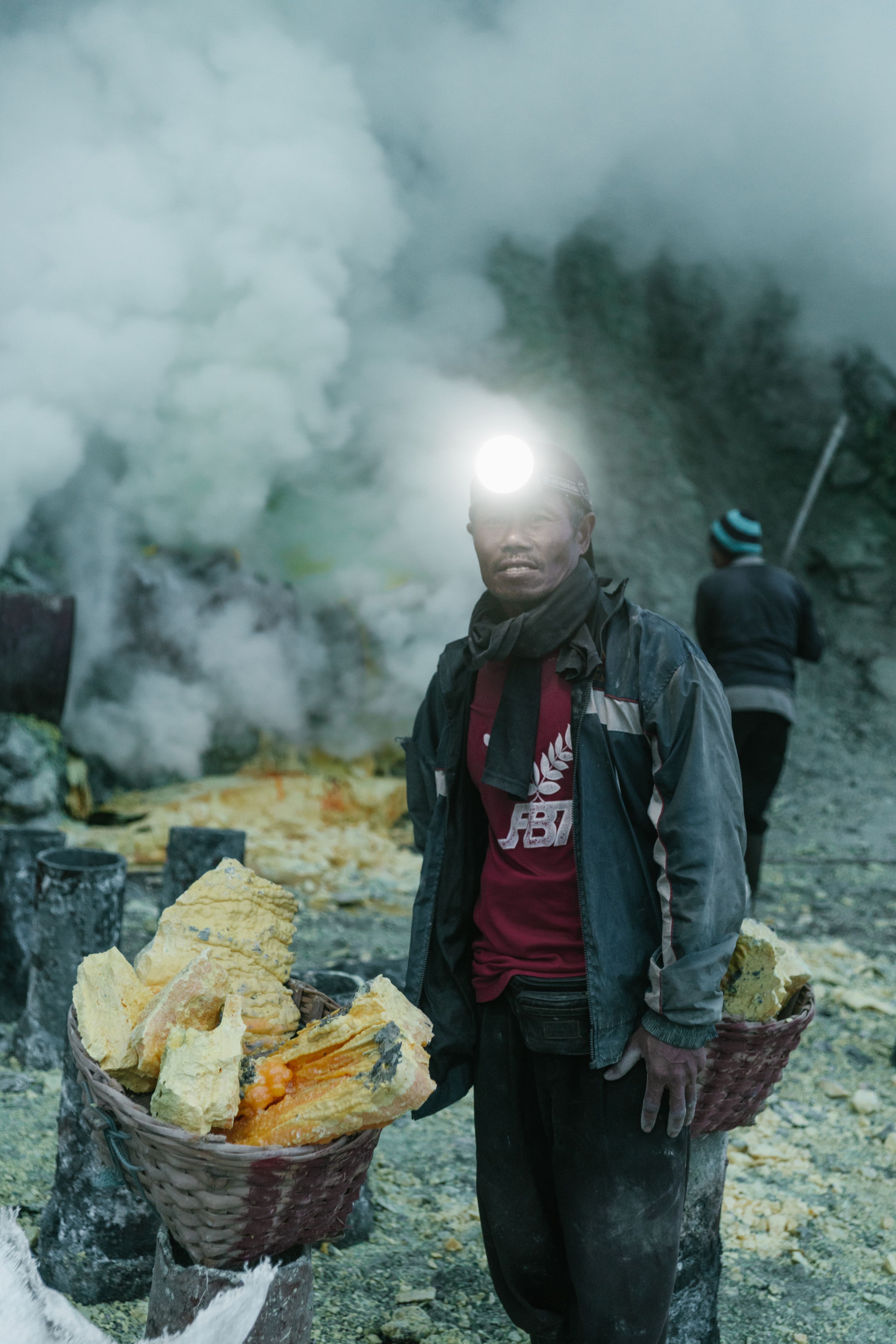 Miner wearing a headlamp and respirator at a working face